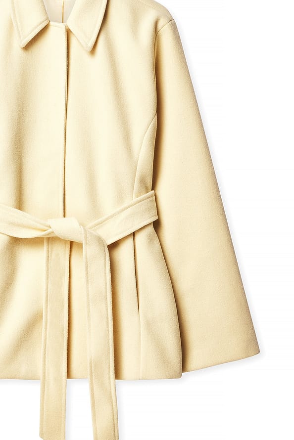 Beige coat with a belt on a white background